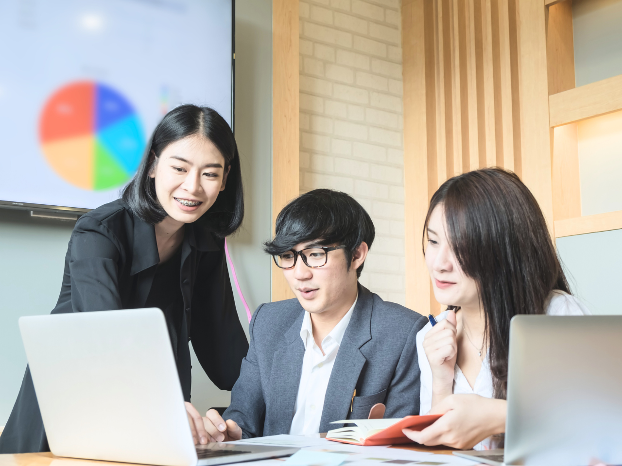 Digital marketing team in Malaysia collaborating on a campaign strategy using data insights and performance analytics.