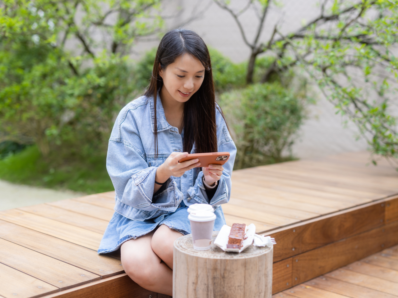 Woman take photo at outdoor cafe
